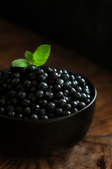 blueberries in round ceramic bowl on wooden table