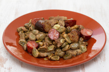 beans with meat and smoked sausages on ceramic dish