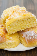 typical portuguese buns with coconut on white plate