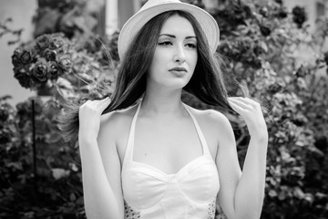 Beautiful and attractive redhead lady with colorful vintage makeup. She rest on weekend in garden. Woman have a sad mood and she alone