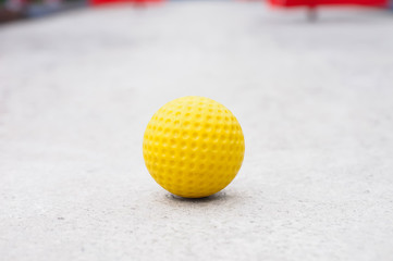 Isolated yellow golf ball