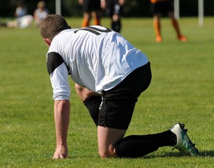 genou &agrave; terre au football
