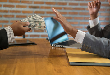 Businessman rejecting money cash banknote from a man.  honest business people in suit refuse to...