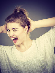 Unhappy woman screaming and yelling in pain