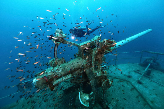 ship wreck in tropical sea ,cannon tower of a sunken ship with scuba diver,H.T.M.S. Prab Wreck Dive, Koh Ngam Noi Island , Chumphon Province Thailand