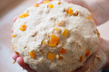 a baker holding bread dough