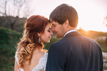 Stylish wedding on a nature. Walk of lovers at sunset. A beautiful love story. Film colors.