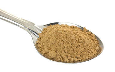 Seasoning mix for beef stew in a spoon against a white background.