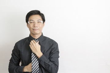 Asian businessman standing on grey background