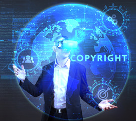 The concept of business, technology, the Internet and the network. A young entrepreneur working on a virtual screen of the future and sees the inscription: Copyright