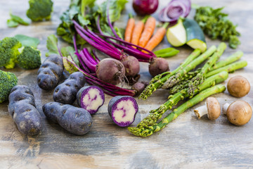 Ingredients for healthy salad with colorful vegetables. Rainbow food on wooden background. 