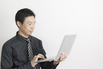 Asian businessman holding laptop