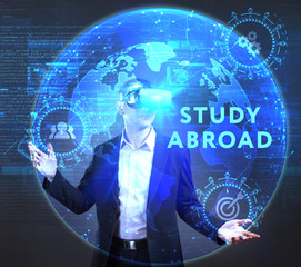 The concept of business, technology, the Internet and the network. A young entrepreneur working on a virtual screen of the future and sees the inscription: Study abroad