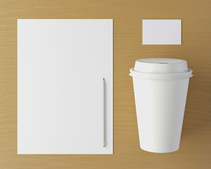 Corporate stationery set mockup. Blank brand ID elements, card, pencil and white coffee cup on a wooden table. Top view. 3D rendering.