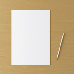 Corporate stationery set mockup. Blank white brand ID elements, paper sheet and pencil on a wooden table. Top view. 3D rendering.