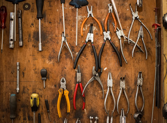 Mechanic, complex tool on the wall, all kinds of pliers, a private car service