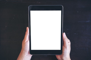 Mockup image of woman's hands holding black tablet pc with blank white screen with black background