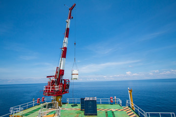 Pedestal crane, crane operator during operate crane with blue sky