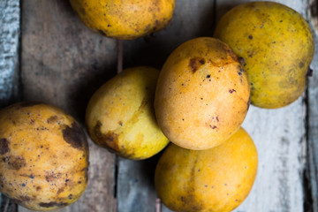 Top view of mango fruit isolated on the old wooden table background