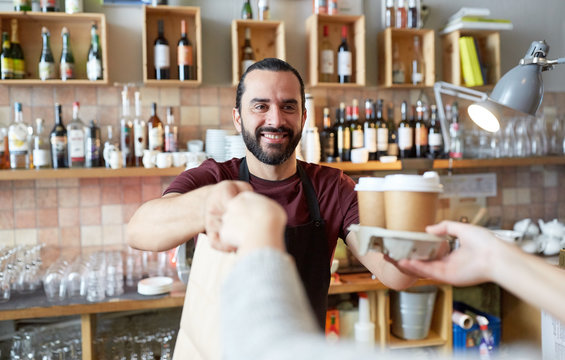 Man Or Waiter Serving Customer At Coffee Shop