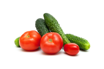 Tomatoes and cucumbers isolated on white background.