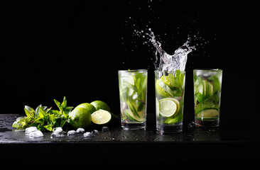 Mojito summer beach refreshing tropical cocktail non alcohol drink in highball glass with splash soda water, lime juice, mint leaves, sugar, ice and rum