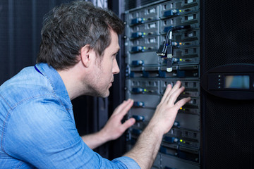 Handsome male technician checking Internet cables