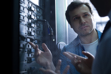 Nice professional technician listening to his colleague
