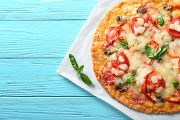 Tasty pizza on wooden table