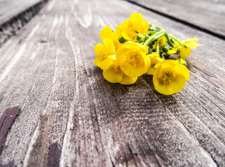 Yellow flowers on a wooden table