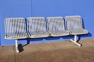 Steel white chairs in purple wall