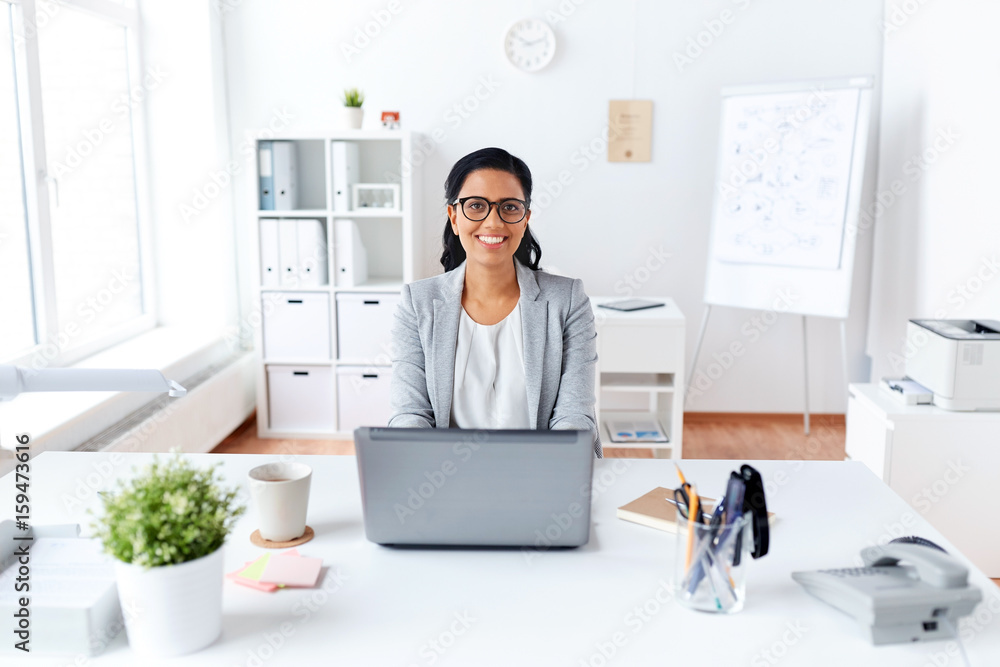 Sticker happy businesswoman with laptop working at office