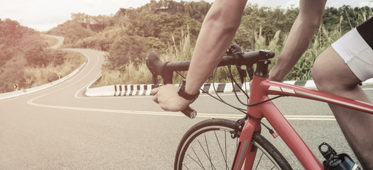 Asian men are cycling road bike in the morning.downhill