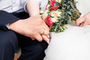 Newly wed couple's hands with wedding rings