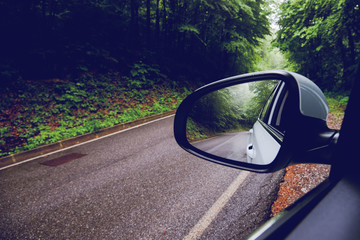 side mirror of a modern car in a rainy day