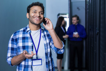 Happy joyful man having a phone conversation