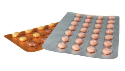 Oral contraception concept. Two packages of birth control pills on white background