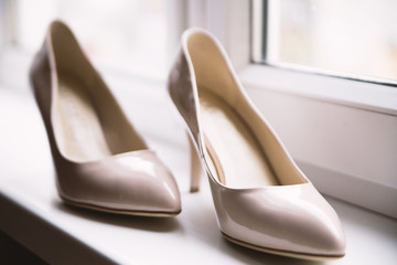 Wedding  shoes by the window. Wedding charges