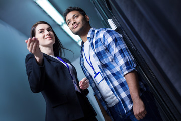 Joyful helpful woman standing with her colleague