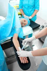 Obraz premium Vertical shot of a young woman undergoing surgery receiving anesthetics injection from a nurse healthcare medicine ambulance concept.