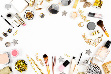 Cosmetics frame with lipstick, brush and other accessories on white background. Composition in gold colors. Flat lay, top view.