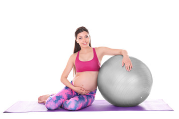 Fototapeta na wymiar Young beautiful pregnant woman doing yoga exercise isolated on white