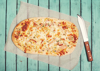 Traditional Alsatian Pie, Tart Flambe or Flammkuchen and Knife on Shabby Chic Vintage Wooden...
