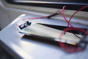 mobile phone and headset on the table in a train