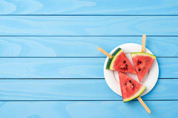 Watermelon slices on blue wooden table. Food background
