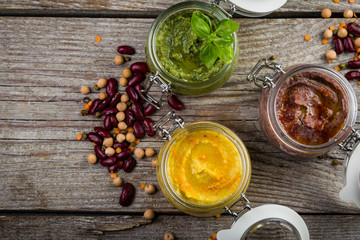 Selection of colorful hummus in jars