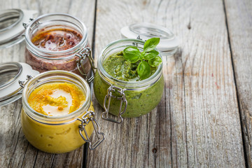 Selection of colorful hummus in jars