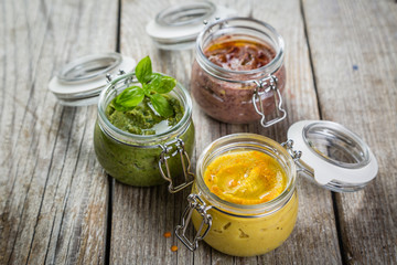 Selection of colorful hummus in jars