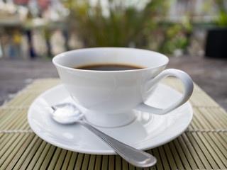 Coffee time, white cup of black coffee on table