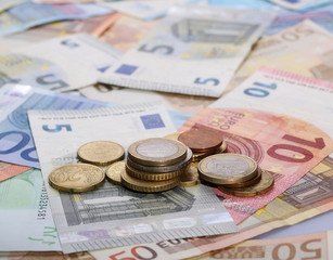 Euro bank notes with metal coins, bills background and texture